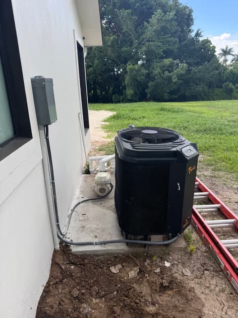 Nueva unidad condensadora de aire acondicionado instalada junto a una casa